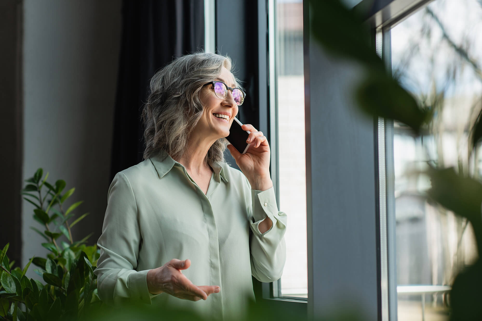 happy_mature_woman_talking_on_phone_looking_up